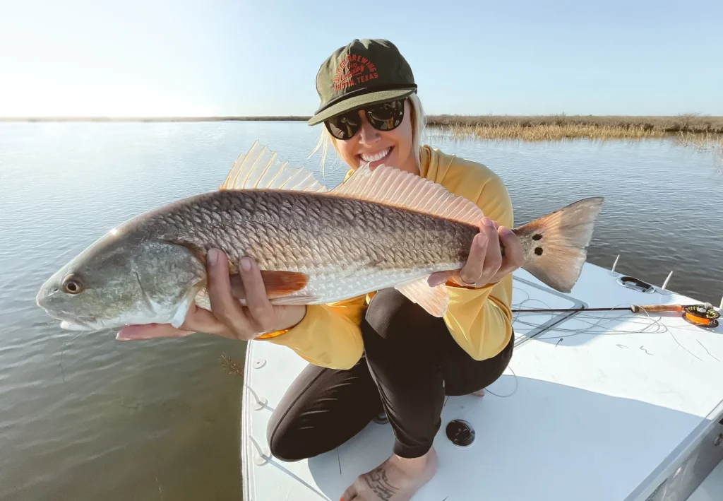 texas fly fishing girl holding redfish